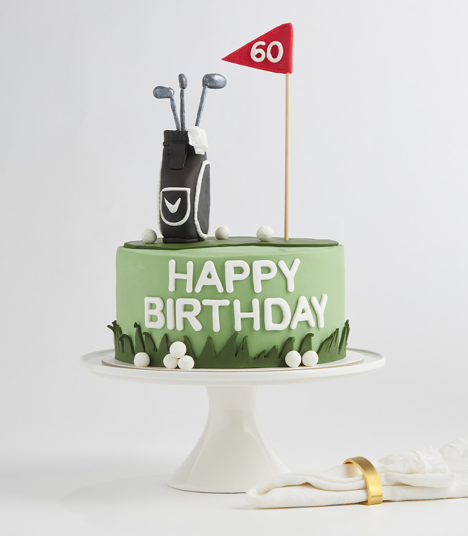 Charlotte Bakery golf-themed birthday cake with fondant golf bag, flag topper, and green icing.