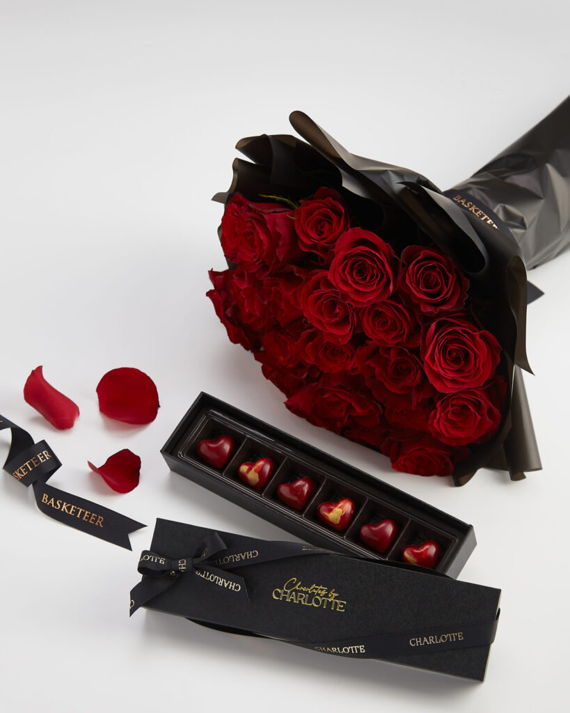 Luxury Valentine gift set with premium red roses and handcrafted heart chocolates by Charlotte Bakery, paired with flowers by Basketeer.