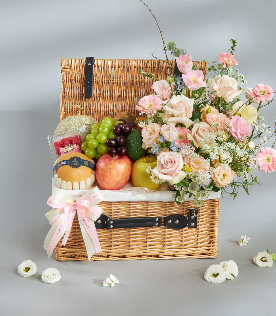 Healthy fresh fruit and pastel floral gift basket.