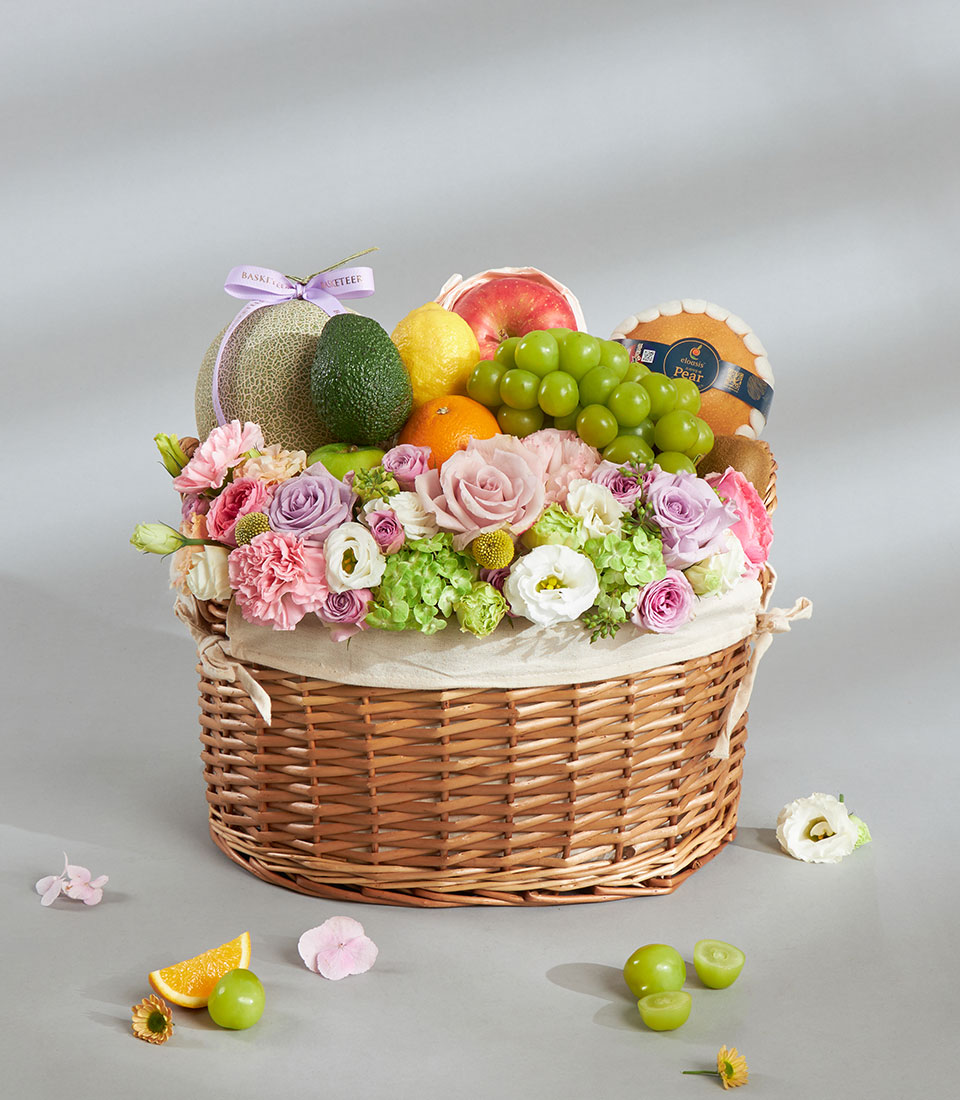 Healthy fresh fruit and pastel floral basket.