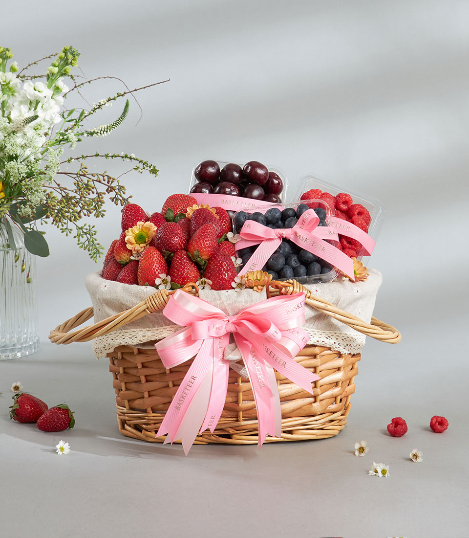 Gourmet fresh berry basket with strawberries, cherries, and blueberries.