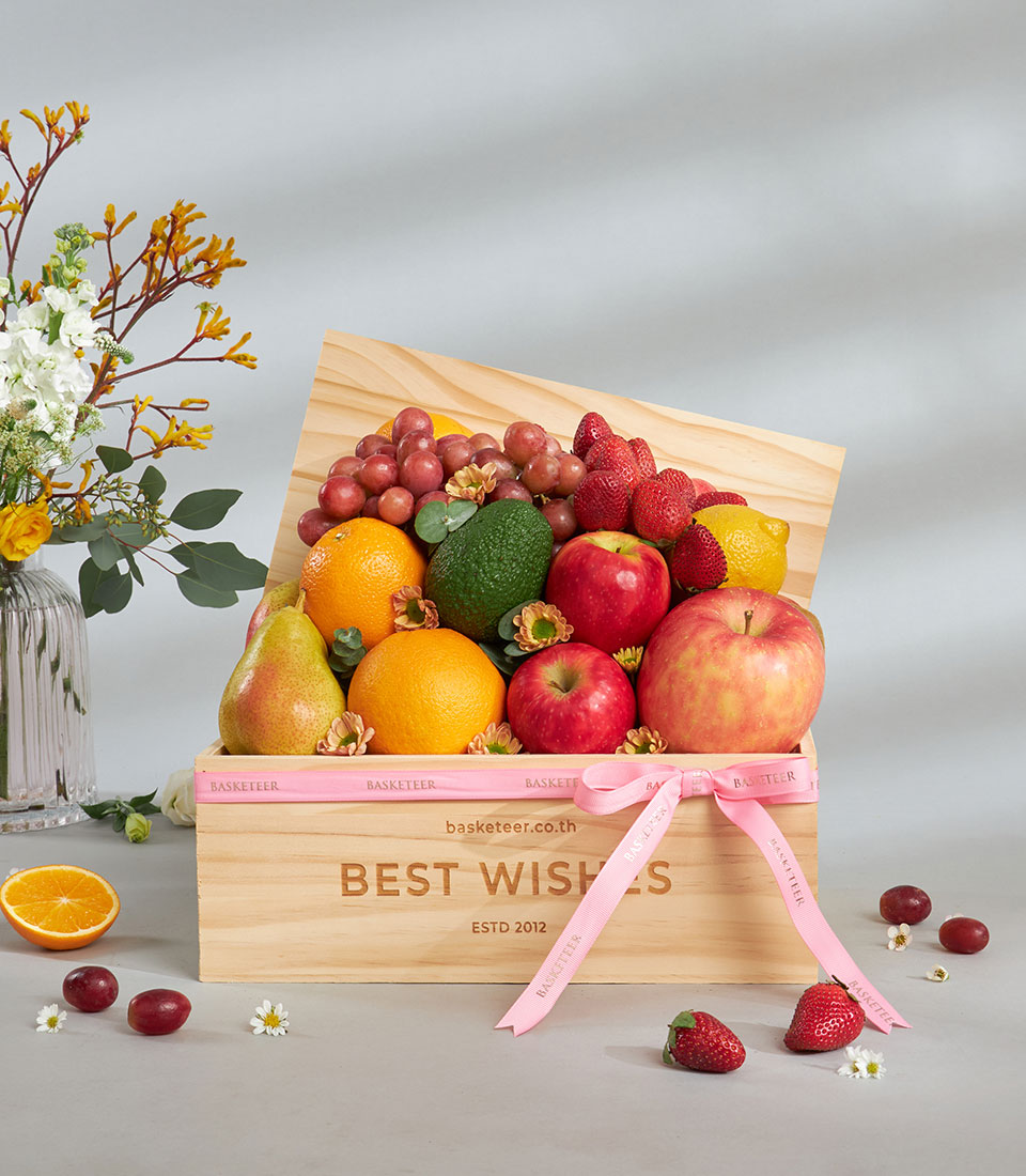 Premium fresh fruit basket in wooden crate with assorted fruits.