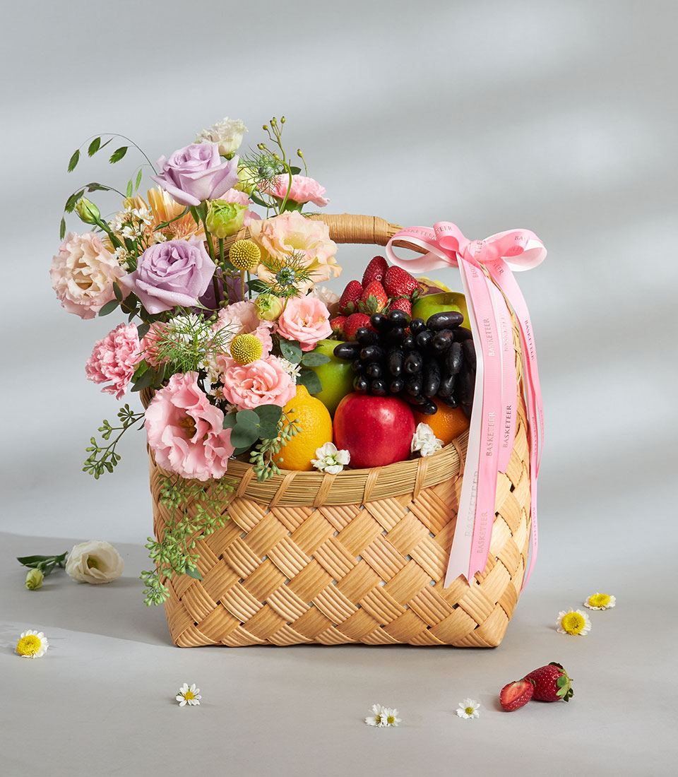 Pastel flower fruit basket with mixed fresh fruits