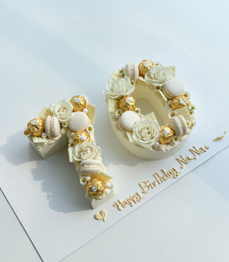 Custom letter cake by Charlotte Bakery featuring classic sponge layers and restrained decoration.