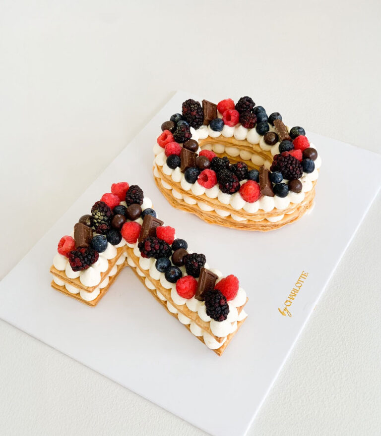 Personalised letter cake crafted with sponge and cream by Charlotte Bakery.