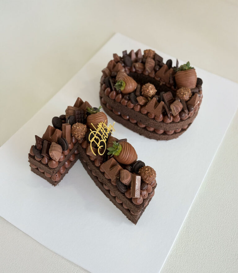 Soft sponge letter cake by Charlotte Bakery with balanced cream.