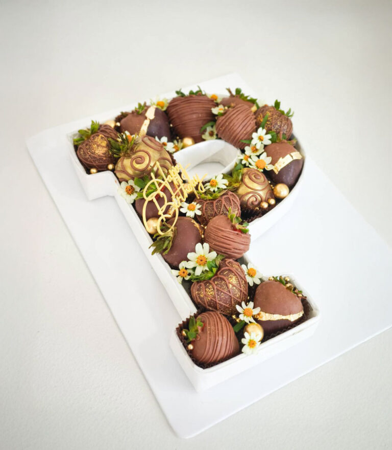 Vanilla letter cake from Charlotte Bakery layered with smooth cream and fresh accents.