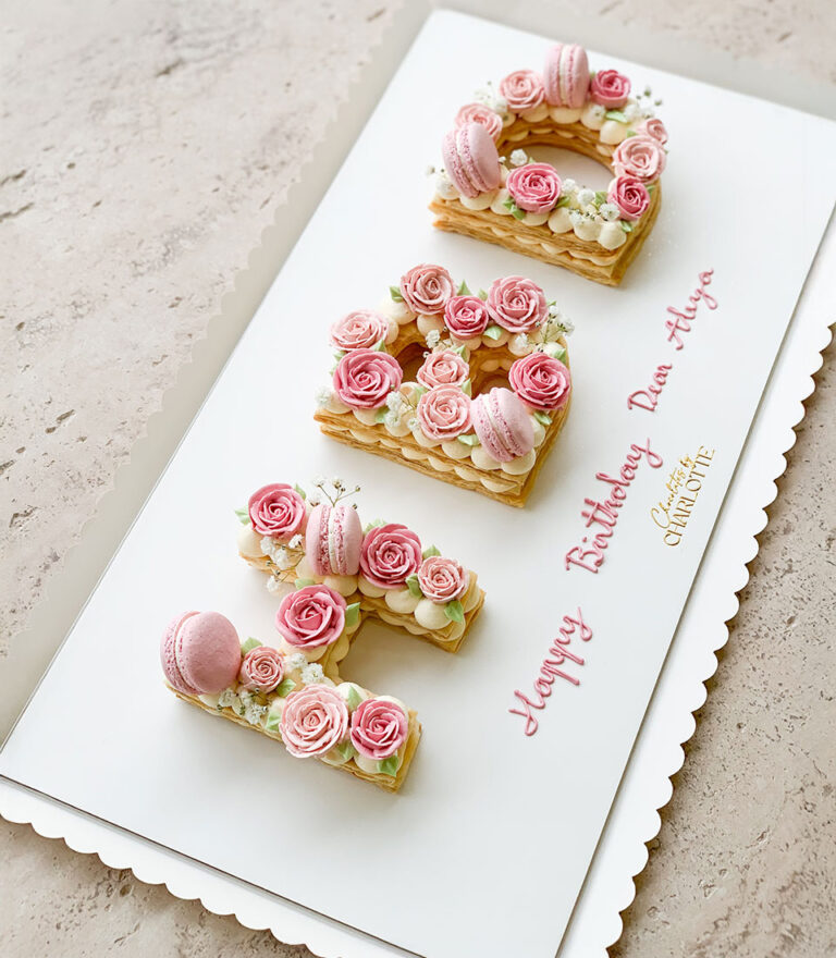 Birthday letter cake by Charlotte Bakery featuring classic sponge and cream.