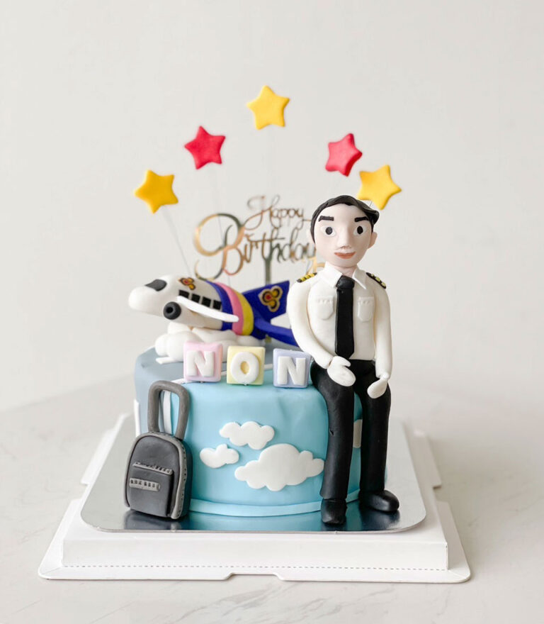 Pilot-themed fondant cake with airplane and uniformed figure by Charlotte Bakery in Bangkok.