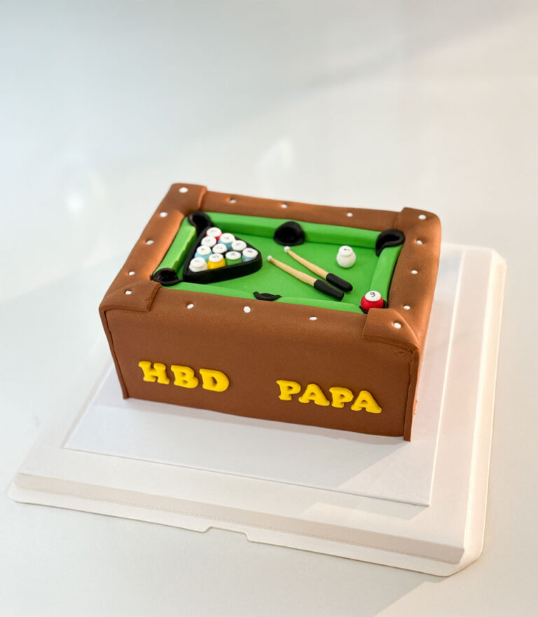 Pool table–themed fondant cake with handcrafted billiard details by Charlotte Bakery in Bangkok.