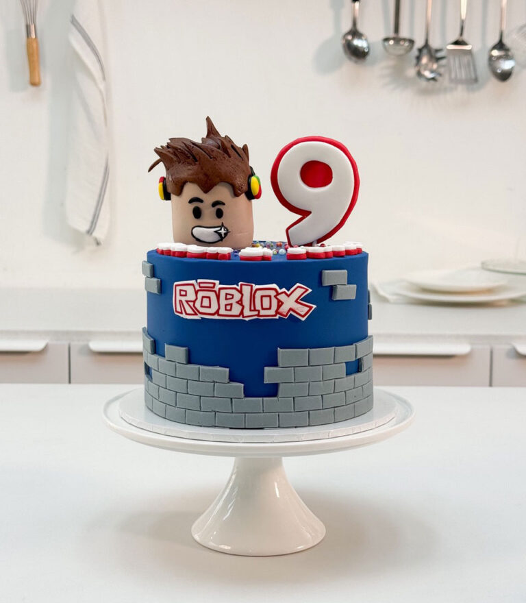 Roblox-themed fondant birthday cake with character figure and number detail by Charlotte Bakery in Bangkok.