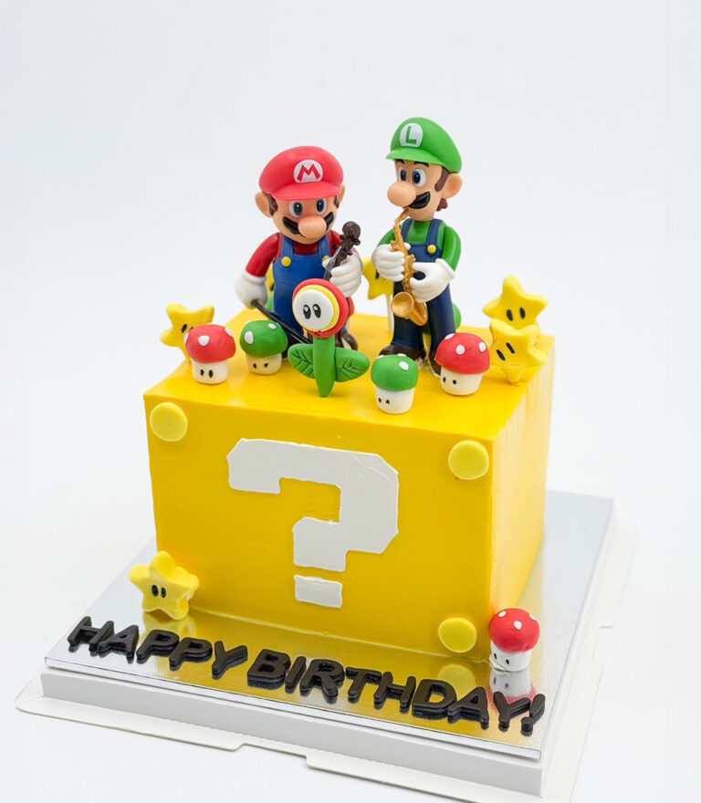 Super Mario–inspired fondant cake with Mario and Luigi figures on a yellow question block by Charlotte Bakery in Bangkok.