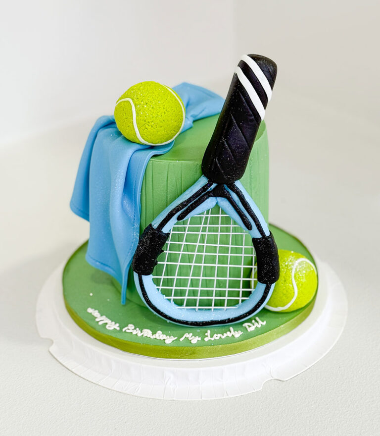 Tennis-themed fondant cake with racket and ball details handcrafted by Charlotte Bakery in Bangkok.