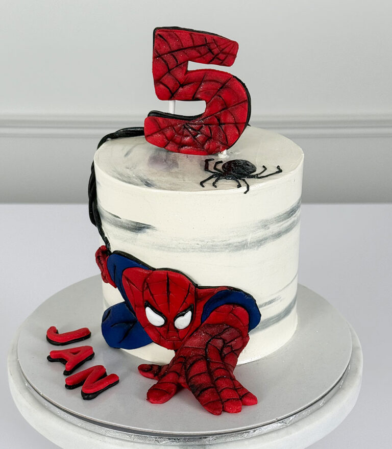 Spider-Man themed birthday cake with number topper and hand-modeled details by Charlotte Bakery in Bangkok