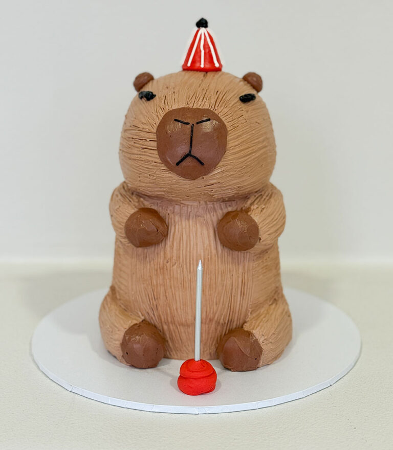 Standing bear–shaped custom birthday cake with sculpted details by Charlotte Bakery in Bangkok.