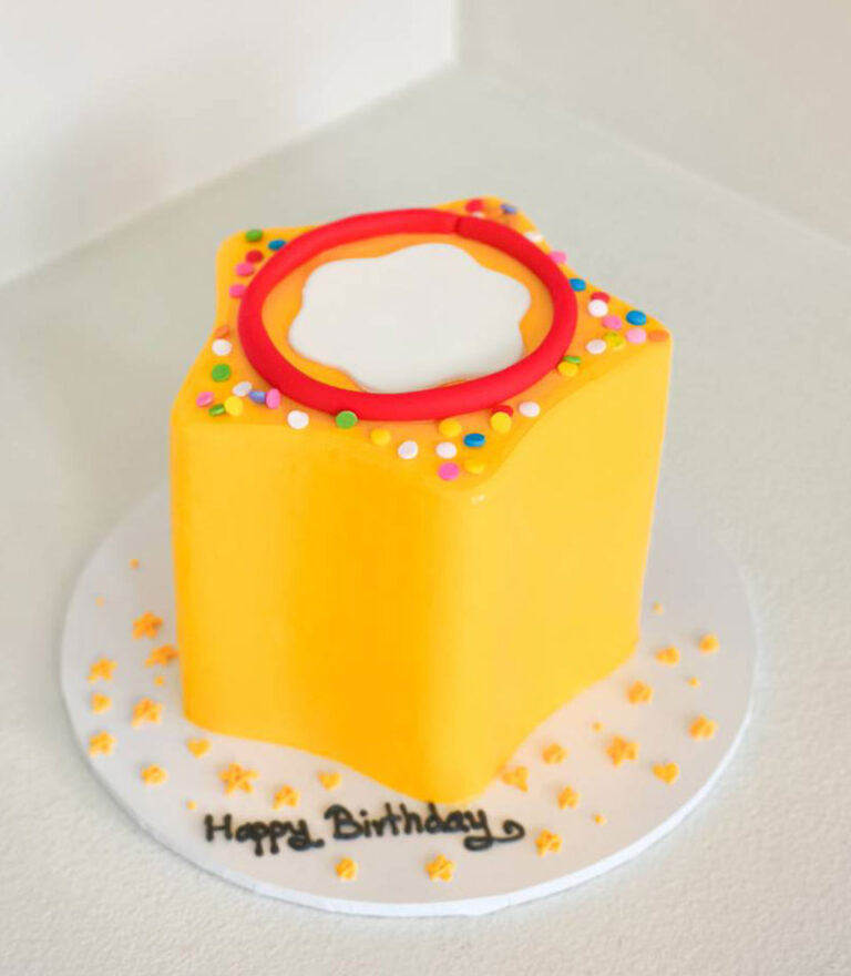 Modern yellow birthday cake with minimal design and colorful sprinkle accents by Charlotte Bakery in Bangkok.