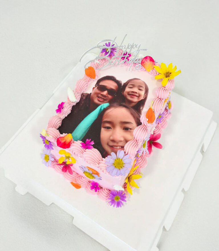 Edible printing birthday cake with custom photo and fresh floral decoration by Charlotte Bakery in Bangkok