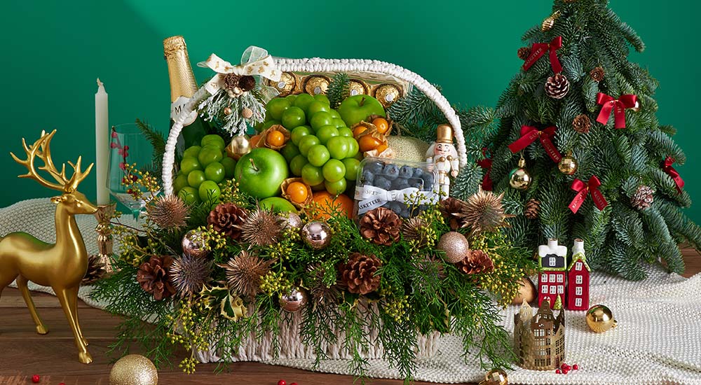 Premium Christmas fruit basket with imported festive fruits, elegant holiday greenery, and wicker basket design, beautifully styled for same-day delivery in Bangkok by Basketeer.