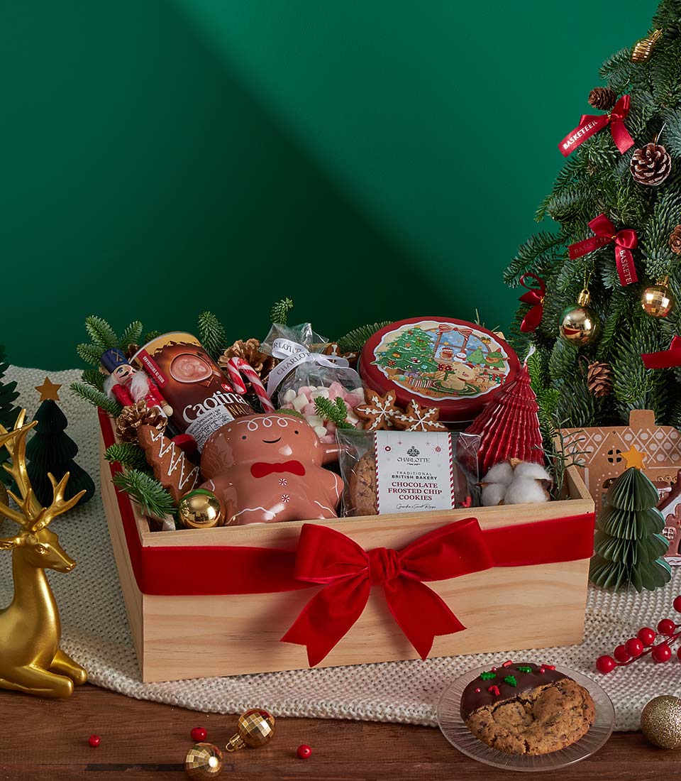 Festive Christmas gift box with gingerbread mug and treats.