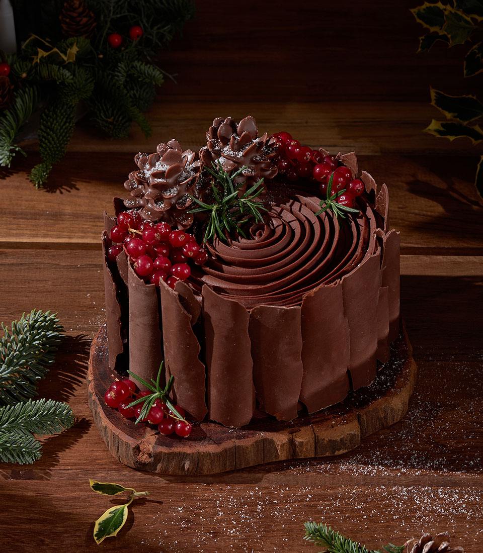Festive chocolate ganache cake with red currants for Christmas celebrations in Bangkok