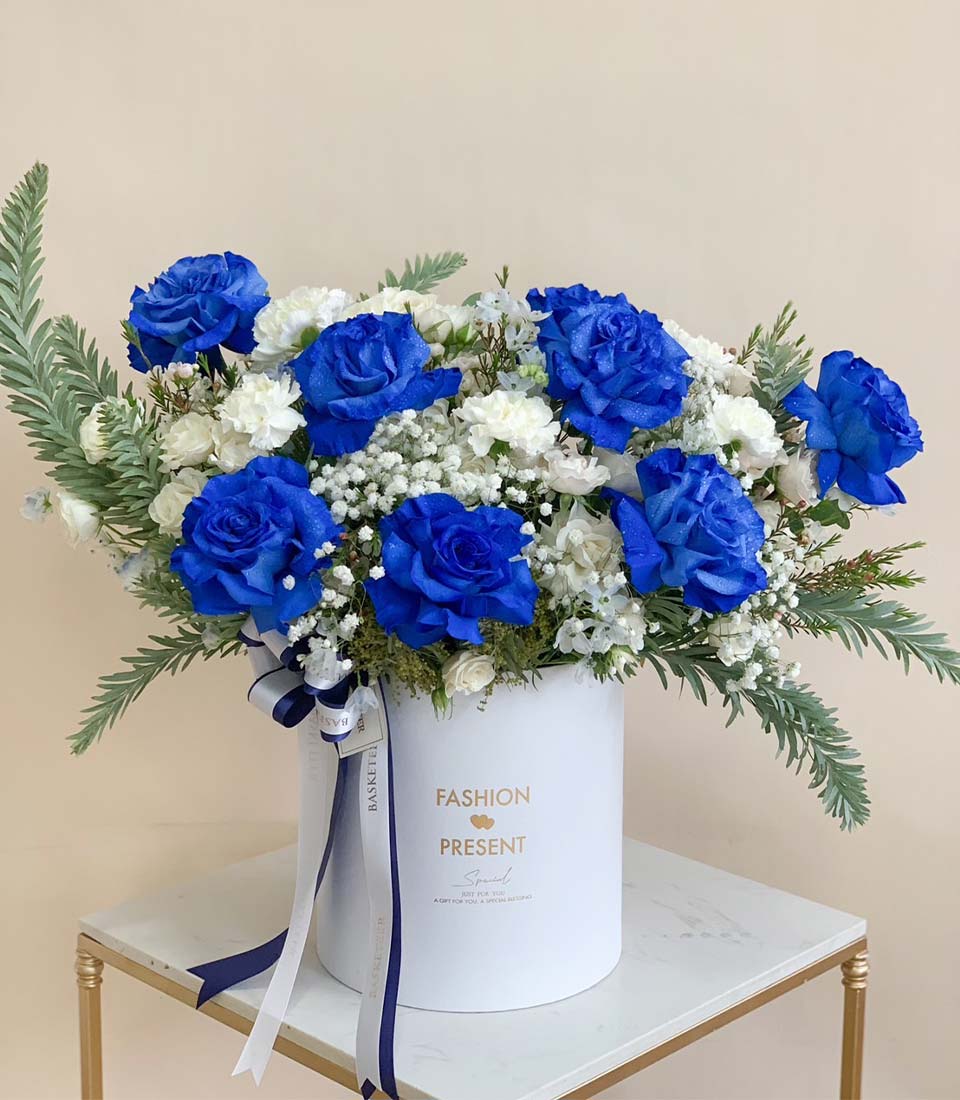 Blue and white rose flower box with delicate filler flowers, styled for elegant luxury delivery in Bangkok.