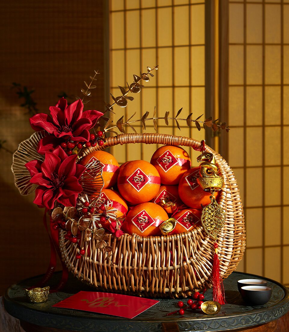 Luxury premium gift basket by Basketeer, featuring fine chocolates, cookies, coffee, tea, and non-alcoholic wine — beautifully arranged in a beige hat box with ribbon, perfect for New Year gifting in Bangkok, Thailand.