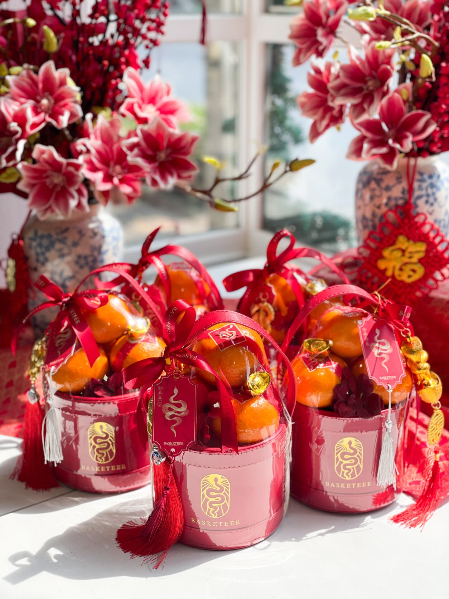 Corporate Chinese New Year gift baskets by Basketeer featuring mandarin oranges in premium red buckets, designed for business gifting in Bangkok.