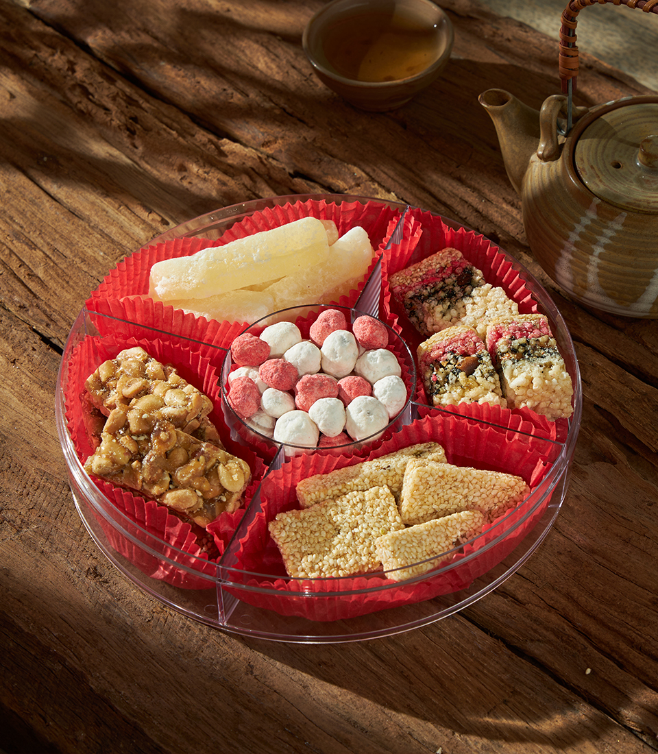 An assortment of traditional Chinese New Year sweets presented with understated elegance, reflecting Charlotte Bakery’s heritage-led approach in Bangkok.