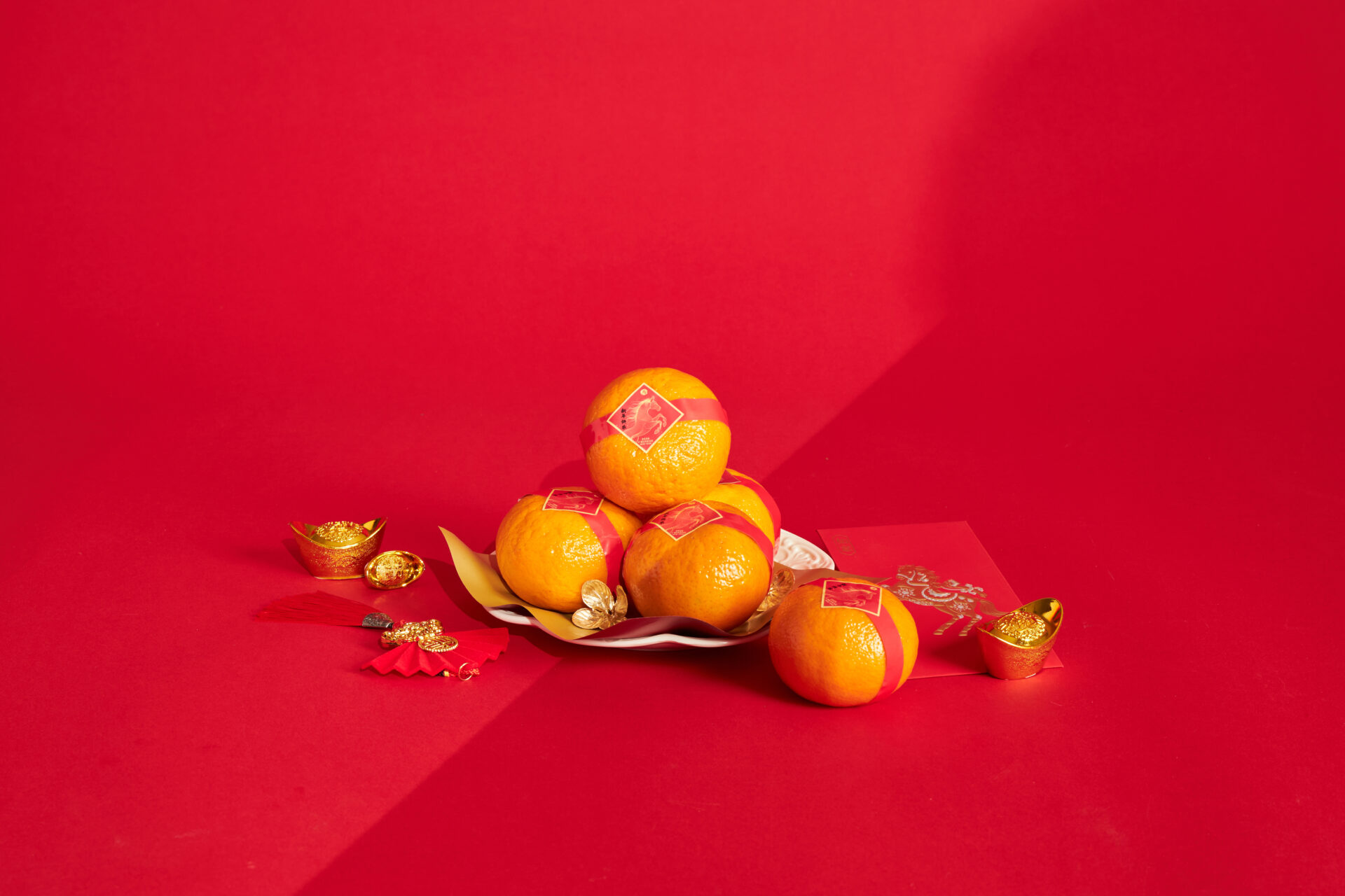 Mandarin oranges wrapped with festive details, presented as a Chinese New Year prosperity gift by Basketeer in Bangkok.