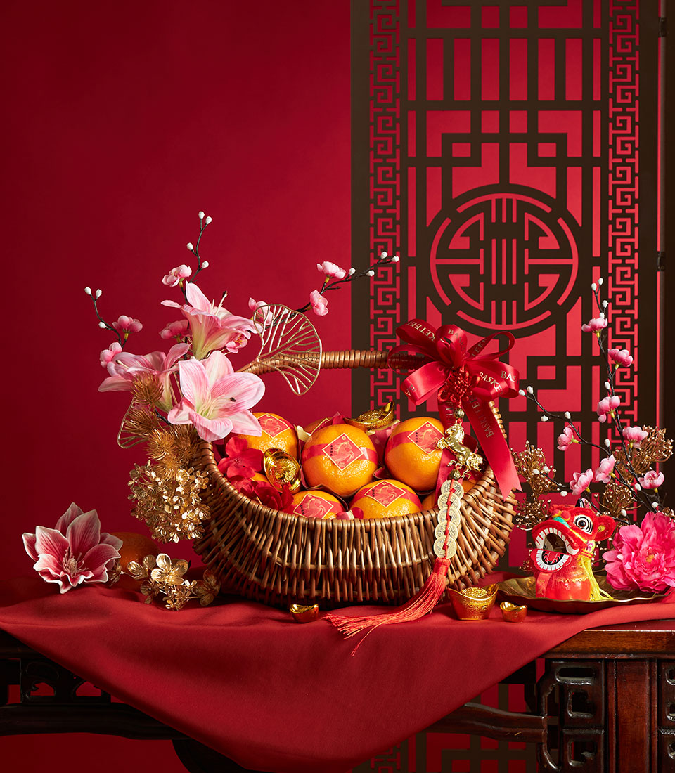 Chinese New Year abundant oranges gift basket with festive florals