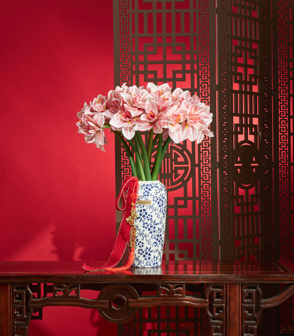 Chinese New Year artificial amaryllis flower vase arrangement in blue and white ceramic vase