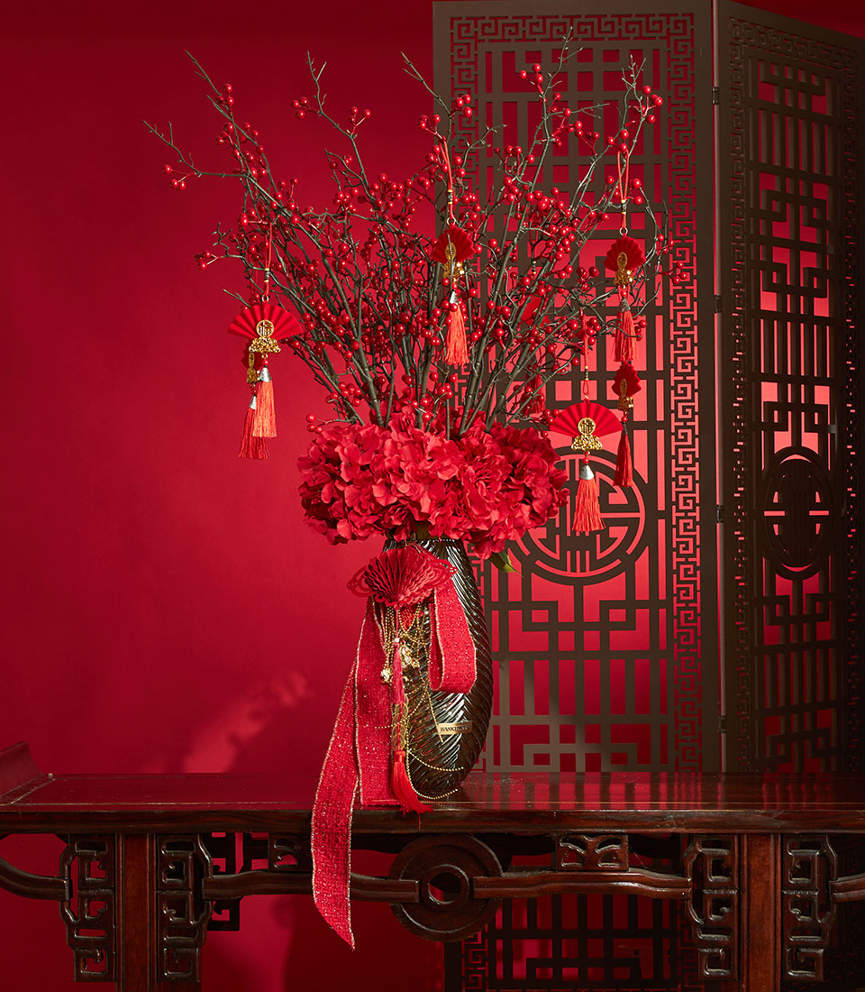 Chinese New Year artificial flower vase arrangement in red tones for festive decor