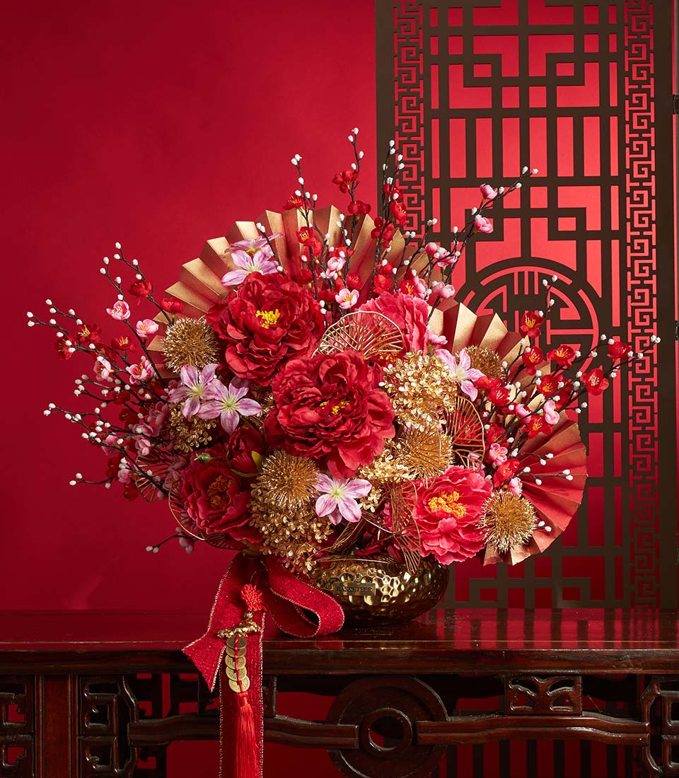 Chinese New Year artificial flower vase arrangement in red and gold tones