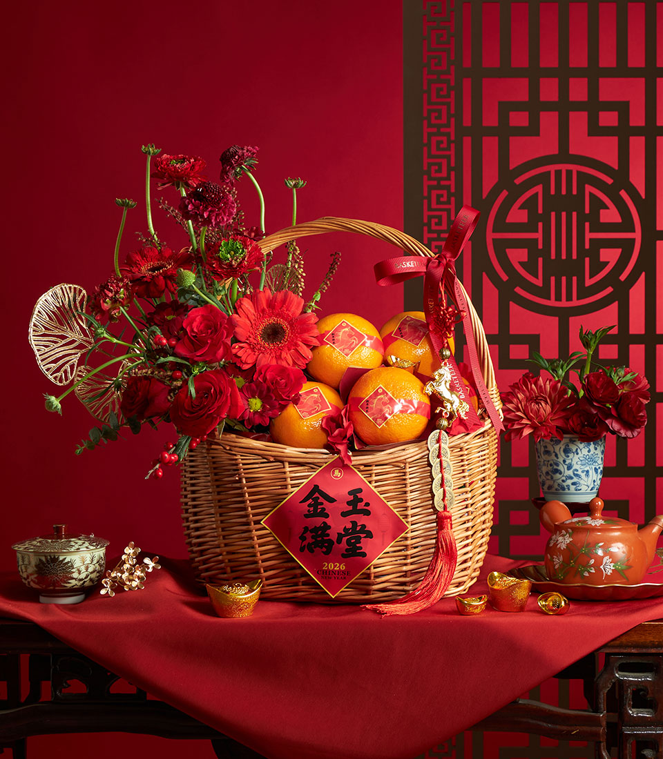 Chinese New Year oranges and blossom gift basket with red flowers and festive decor