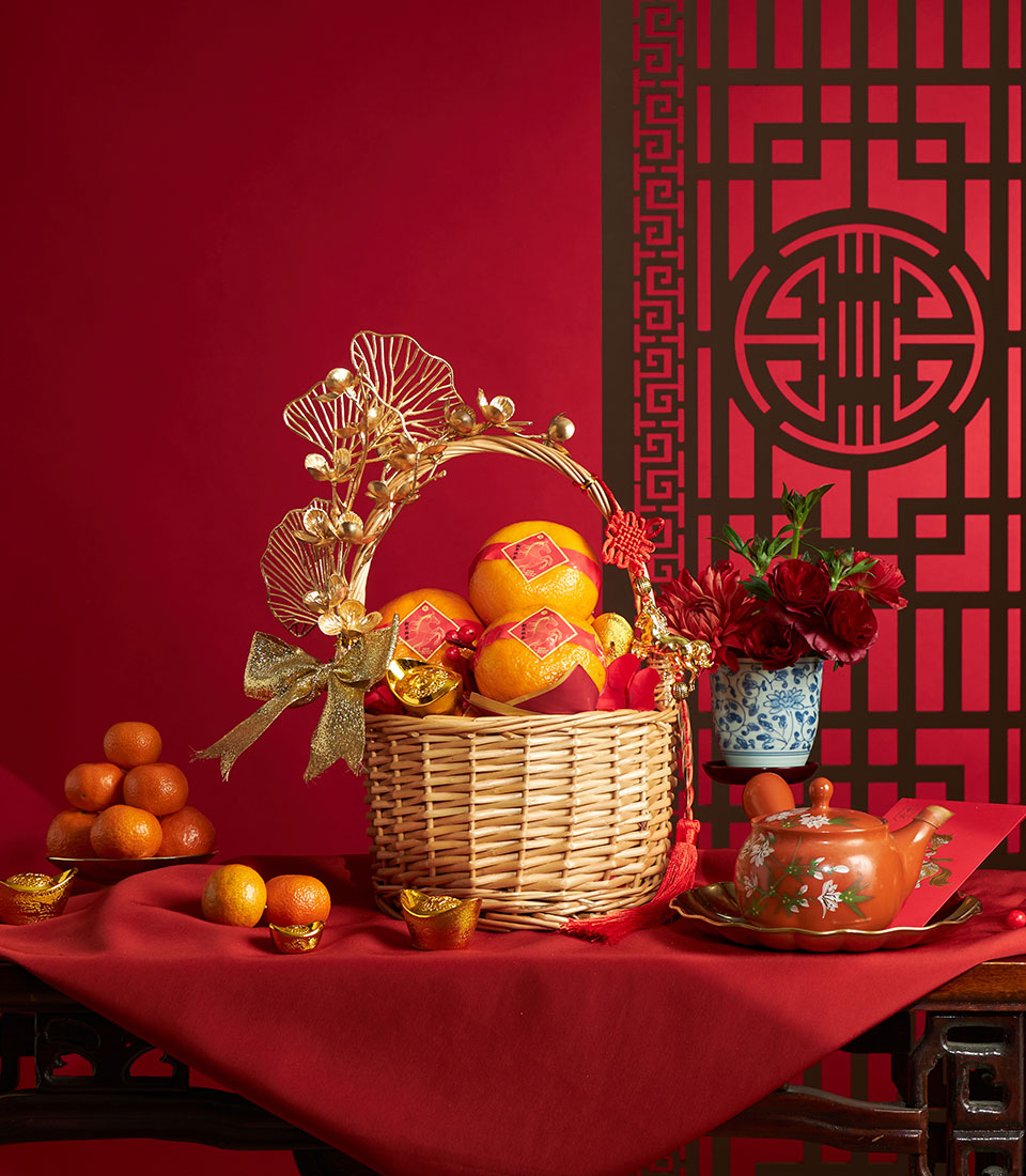 Chinese New Year oranges gift basket with gold blossom decoration and festive styling