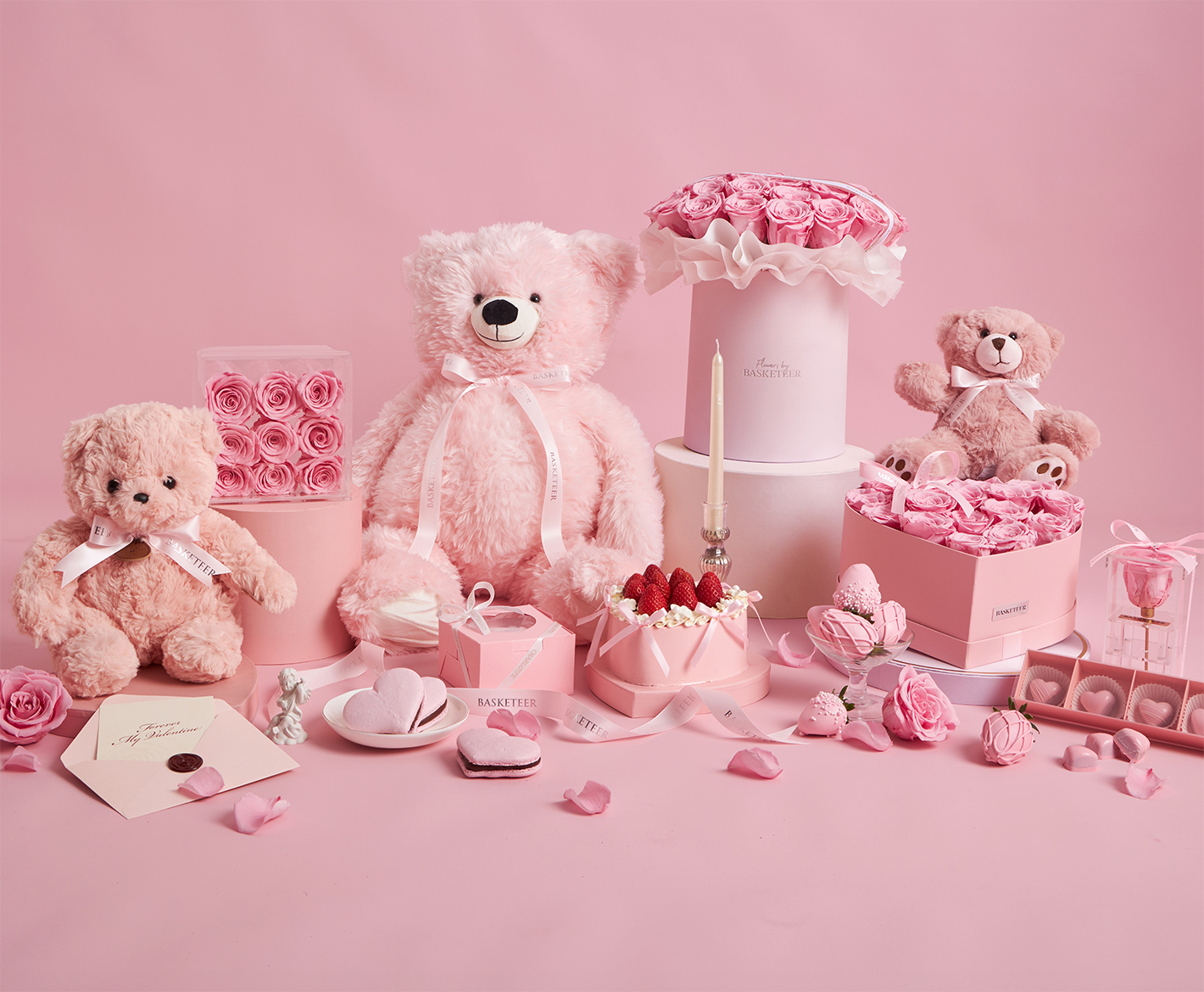 Pink rose hat boxes with teddy bears and romantic Valentine’s gifts by Flowers by Basketeer, styled in an elegant monochrome pink theme in Bangkok.