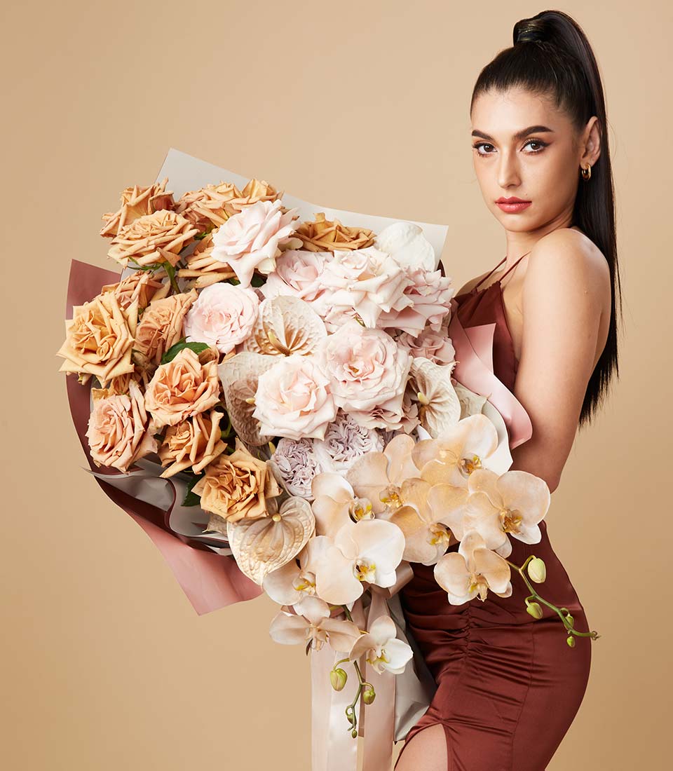 Large luxury bouquet with caramel peach roses and orchids in elegant lifestyle presentation Bangkok delivery