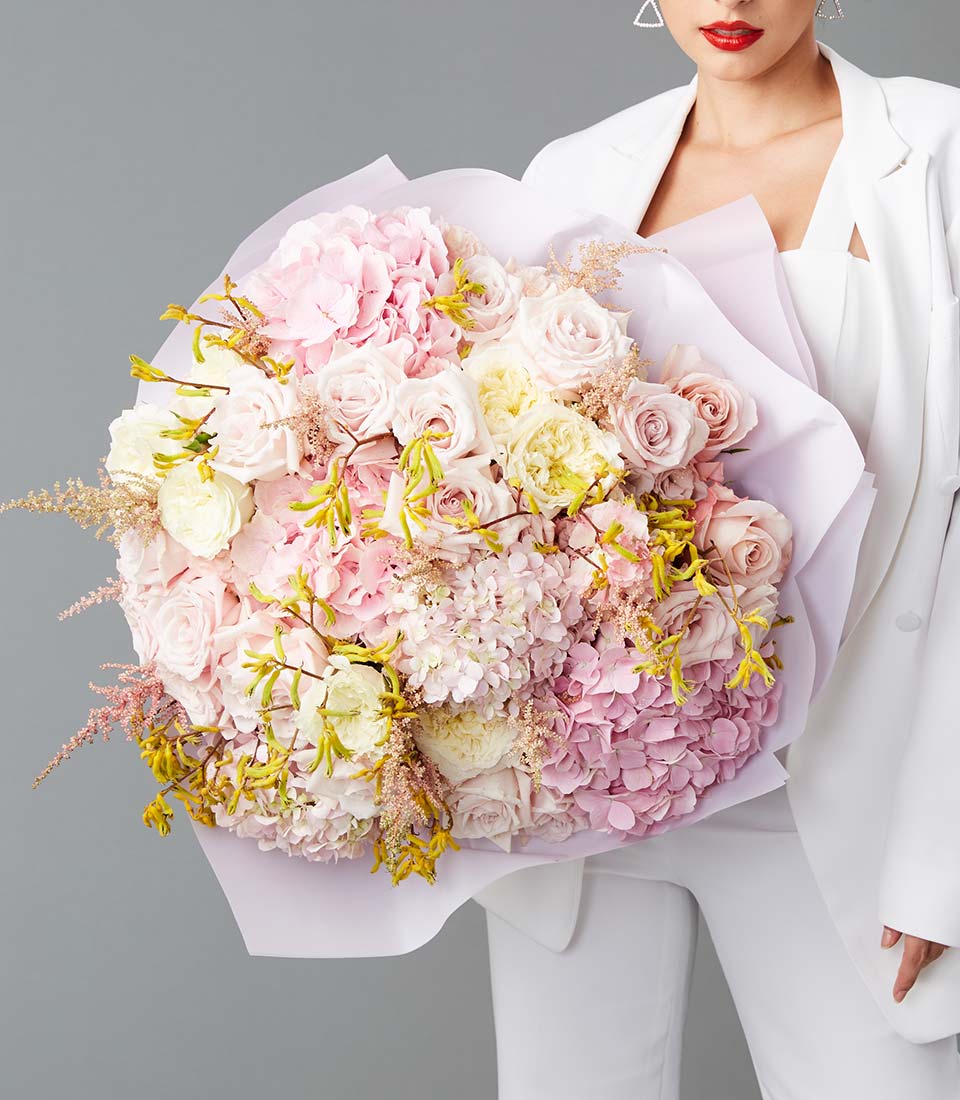 Large pastel bouquet with pink hydrangea roses and yellow accents in elegant arrangement Bangkok delivery