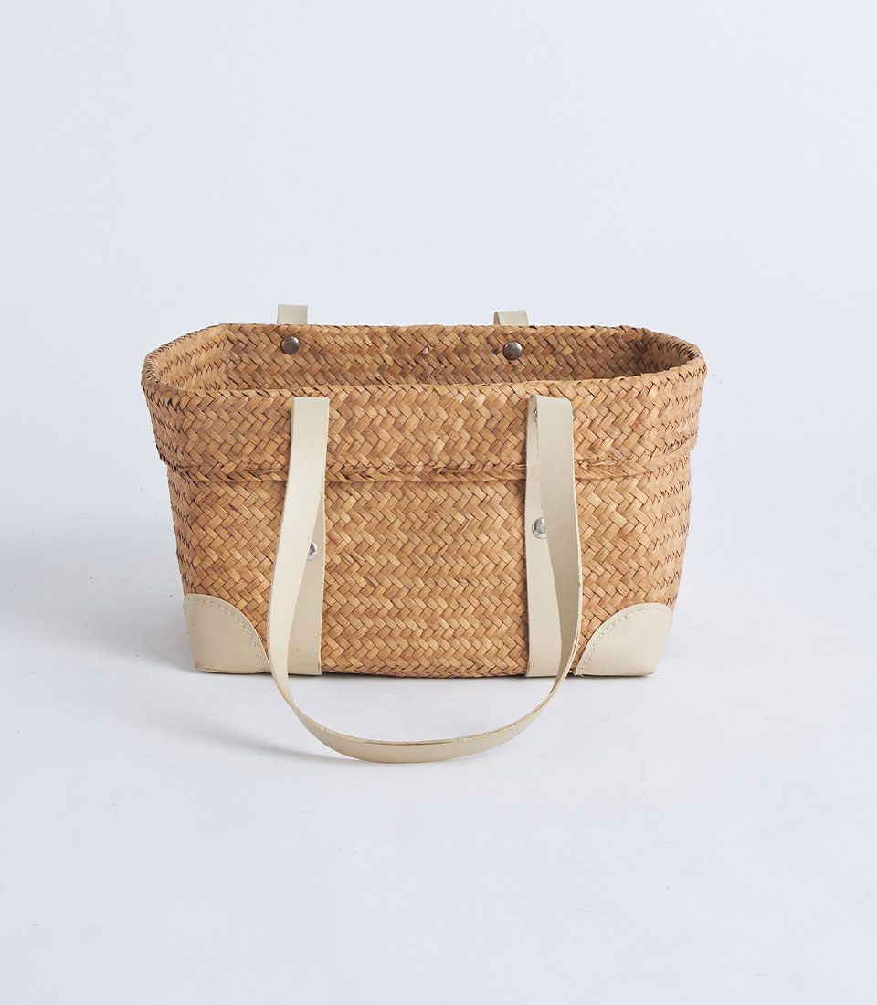 Front view of natural straw basket with cream leather handles BK-046