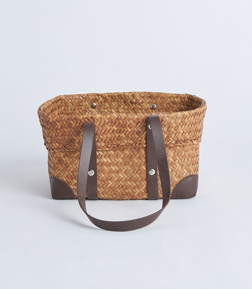 Front view of natural straw basket with dark brown leather handles BK-047